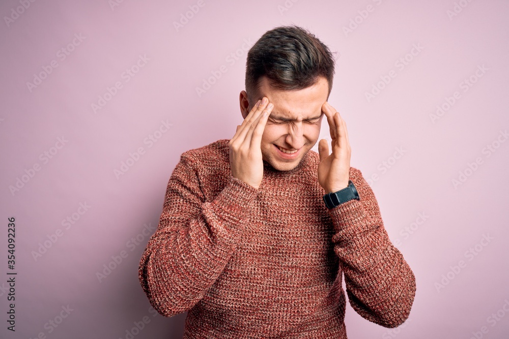 Young handsome caucasian man wearing casual winter sweater over pink isolated background with hand on headache because stress. Suffering migraine. Young handsome caucasian man wearing casual winter sweater over pink isolated background with hand on headache because stress. Suffering migraine.