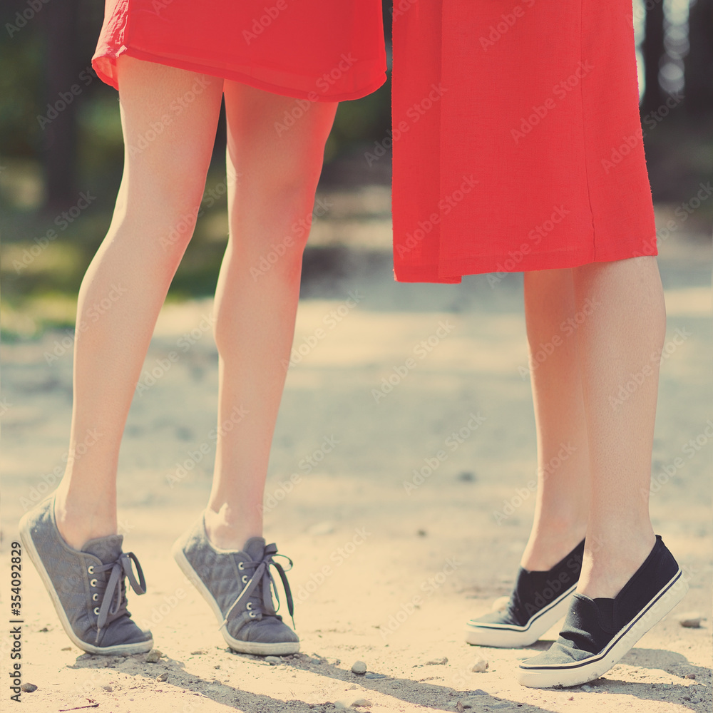 two woman dressed in red dress