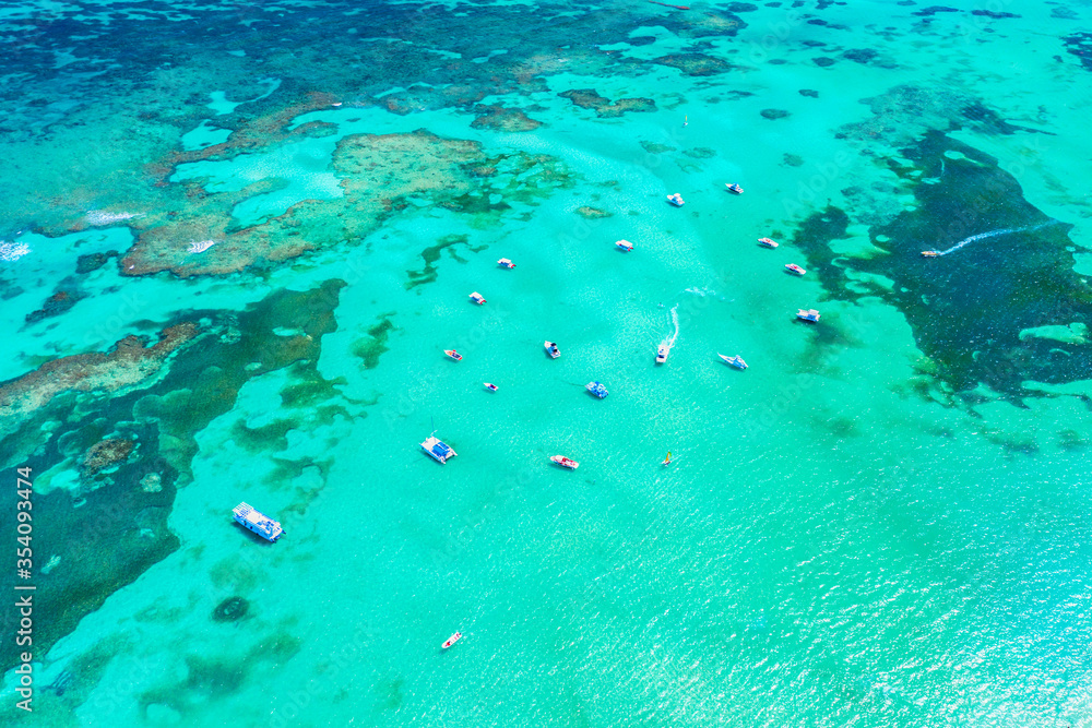 Aerial view of tropical caribbean sea with yachts and boats on blue turquoise ocean. Dominican Republic