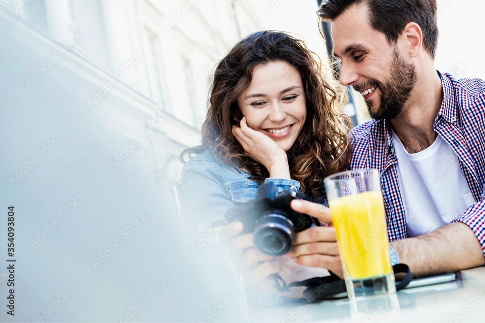 Portrait of young attractive couple looking at their pictures on camera
Portrait of young attractive couple looking at their pictures on camera