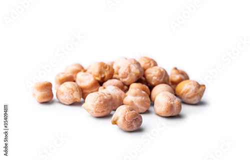 Heap of raw chickpea beans isolated on white background. Healthy vegetarian food concept. Pile of uncooked chickpeas
