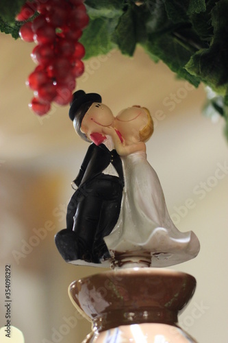 figurine of a bride and groom cuddling