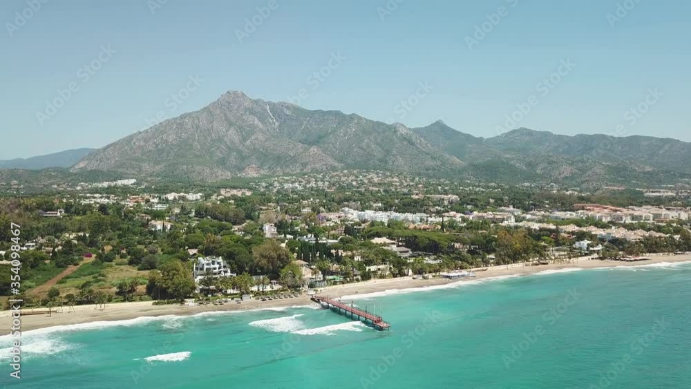 Beautiful and unique cinematic aerial view of luxury and exclusive area of Marbella, golden mile beach, Puente Romano Bridge.Luxury Clubs, Urbanisation in the most expensive area of Marbella. Forward Beautiful and unique cinematic aerial view of luxury and exclusive area of Marbella, golden mile beach, Puente Romano Bridge.Luxury Clubs, Urbanisation in the most expensive area of Marbella. Forward