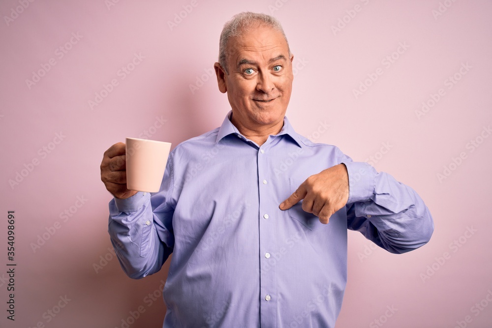 Middle age handsome hoary man drinking mug of coffee over isolated pink background with surprise face pointing finger to himself Middle age handsome hoary man drinking mug of coffee over isolated pink background with surprise face pointing finger to himself