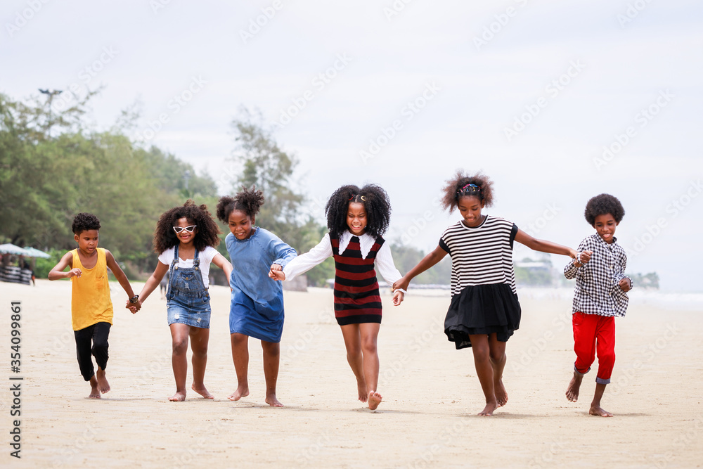 © chayantorn - Funny vacation. Children or kids playing and romp together at the beach on holiday. Having fun after unlocking down the city from COVID19. Seven African American kids. Ethnically diverse concept © chayantorn - Funny vacation. Children or kids playing and romp together at the beach on holiday. Having fun after unlocking down the city from COVID19. Seven African American kids. Ethnically diverse concept