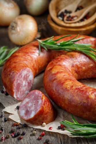 Smoked sausage on a wooden table. Rustic style.