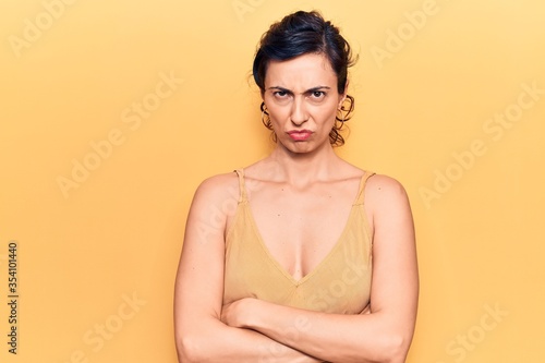Young beautiful hispanic woman wearing casual clothes skeptic and nervous, disapproving expression on face with crossed arms. negative person.