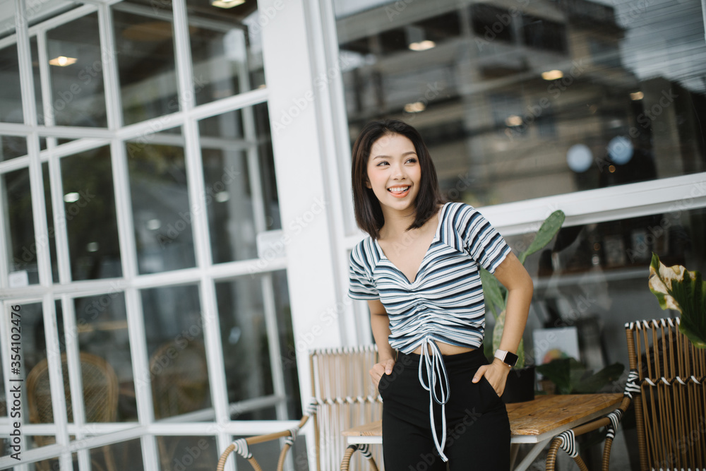 Fototapeta premium Summer sunny lifestyle fashion portrait of young stylish hipster Asia woman walking on the street, wearing cute trendy outfit