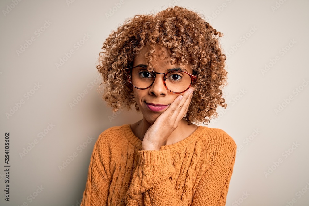 Young african american woman wearing casual sweater and glasses over white background thinking looking tired and bored with depression problems with crossed arms. Young african american woman wearing casual sweater and glasses over white background thinking looking tired and bored with depression problems with crossed arms.
