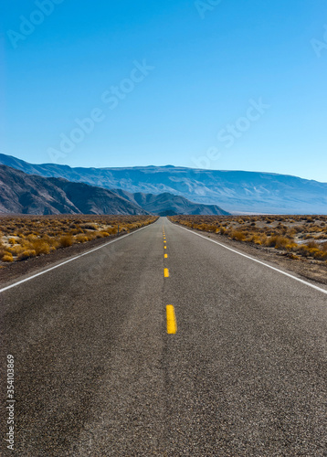 The road intersects the plain and rests against the mountains.