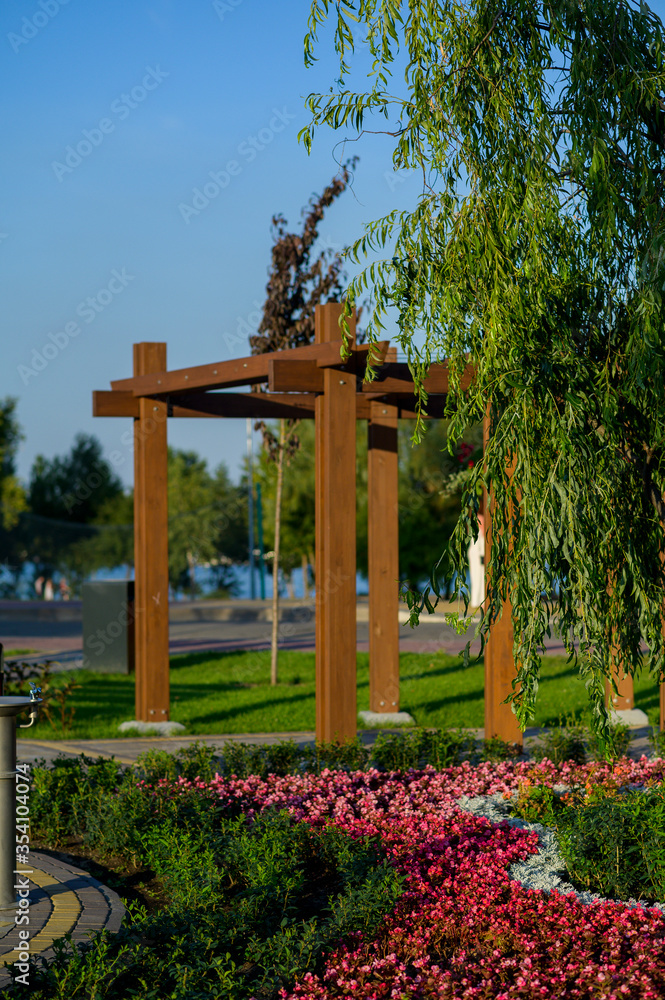 wooden garden arch with landscaping and garden street flowers and plants wooden garden arch with landscaping and garden street flowers and plants