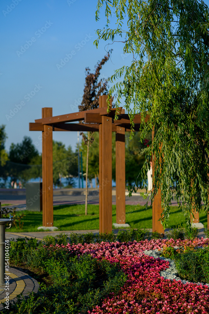 wooden garden arch with landscaping and garden street flowers and plants