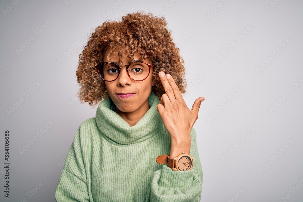 Young beautiful african american woman wearing turtleneck sweater and glasses Shooting and killing oneself pointing hand and fingers to head like gun, suicide gesture. Young beautiful african american woman wearing turtleneck sweater and glasses Shooting and killing oneself pointing hand and fingers to head like gun, suicide gesture.