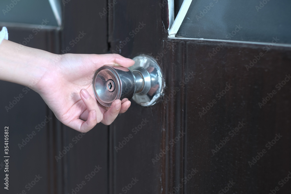 A girl open doorknob to the house A girl open doorknob to the house