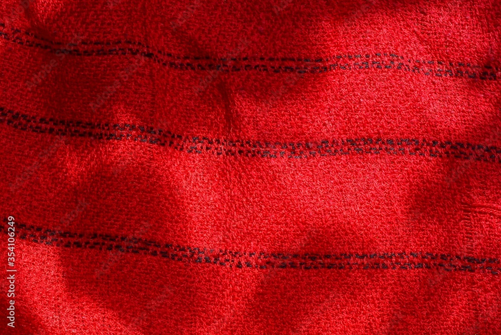 red striped background from a piece of crumpled fabric on clothes red striped background from a piece of crumpled fabric on clothes