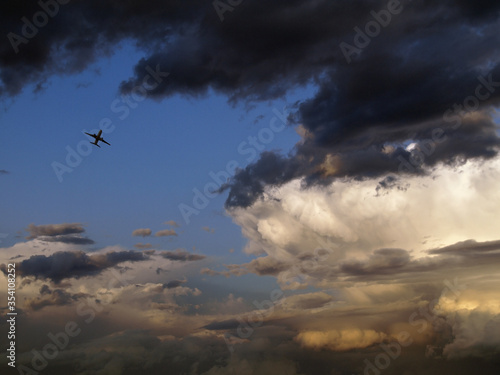 Airplane taking off into a storm at sunset, Barcelona, Spain.