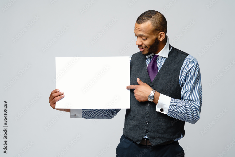 professional african-american business man - presenting holding blank sign