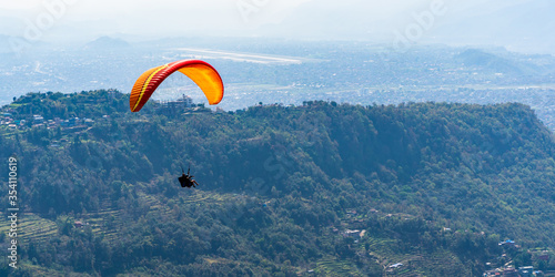 Paragliding in Nepal. Paraglider on the background Pokhara city and surrounding villages. Stock photo. © Dzianis Rakhuba