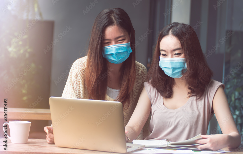 Women wearing mask and working from home