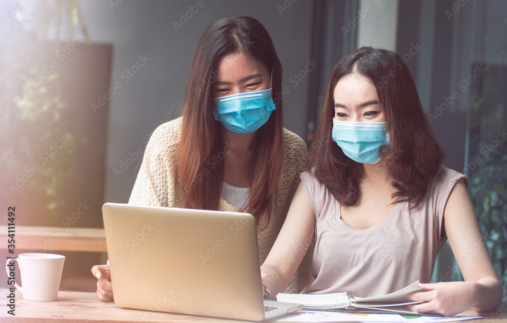 Women wearing mask and working from home Women wearing mask and working from home