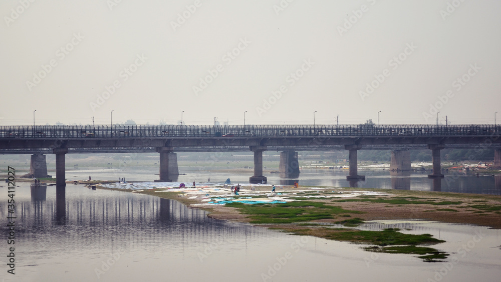 bridge over the Yamuna river and an island where Laundry is dried, India