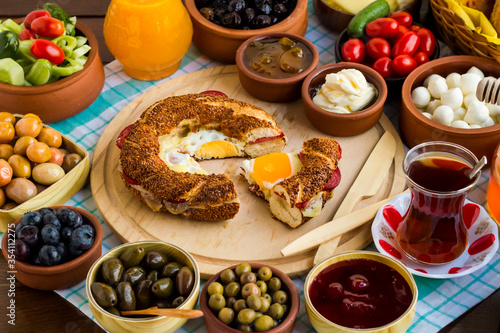 Fresh,Traditional Turkish Village Breakfast on the wooden table.Cooked bagel "simit" with cheese,sausage and egg on the wooden tray.