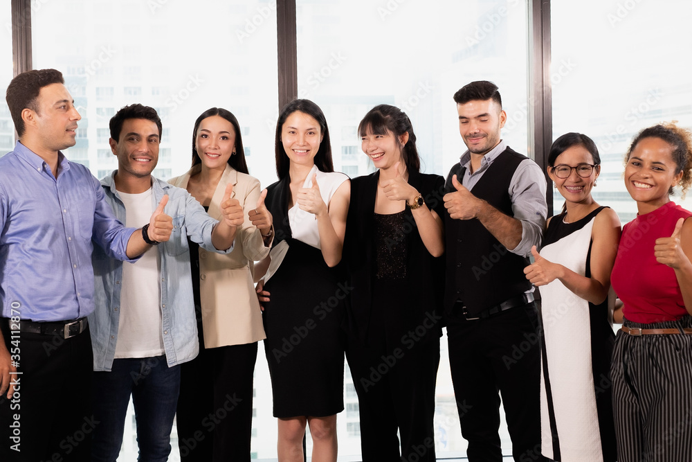 Successful business people with team product thumbs up and smiling for success stategies Successful business people with team product thumbs up and smiling for success stategies