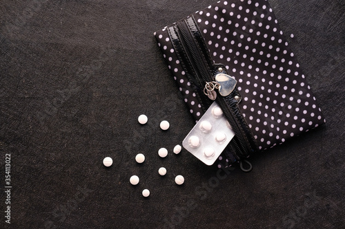 Fototapeta Naklejka Na Ścianę i Meble -  top view of white medicine and blister pack on black background 