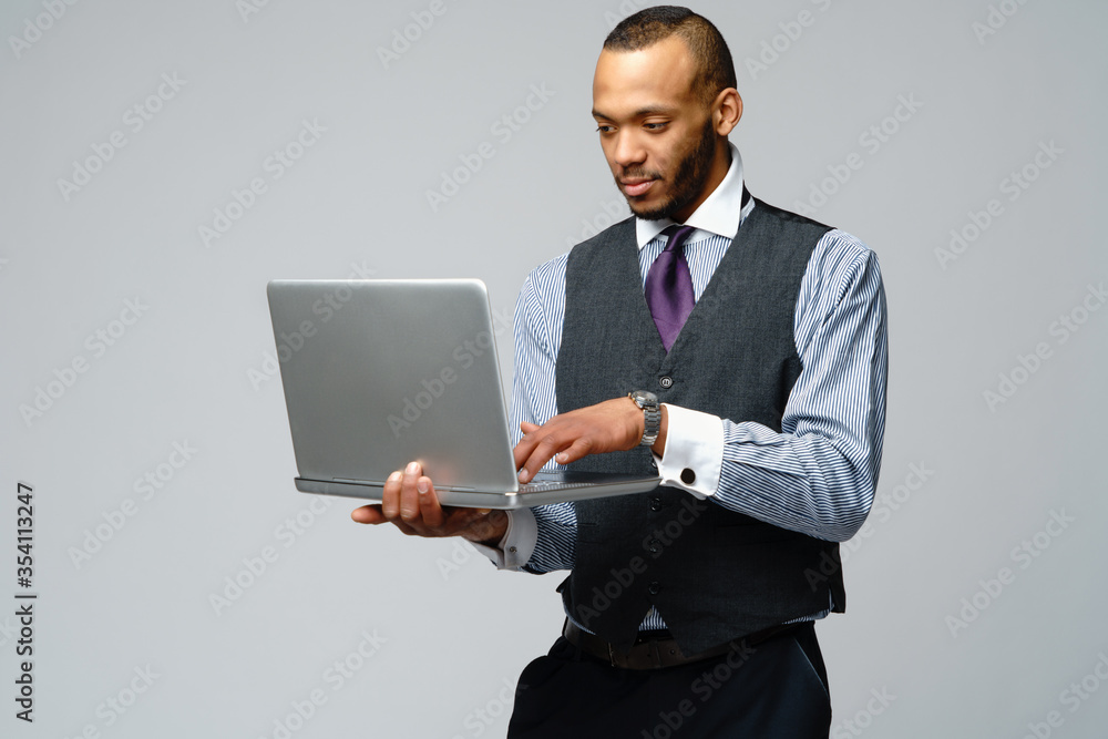 professional african-american business man holding laptop computer professional african-american business man holding laptop computer