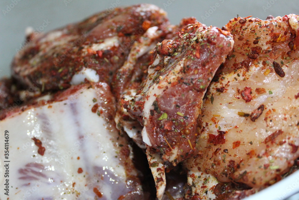 preparation of pork meat on the ribs with spices Provencal herbs for frying