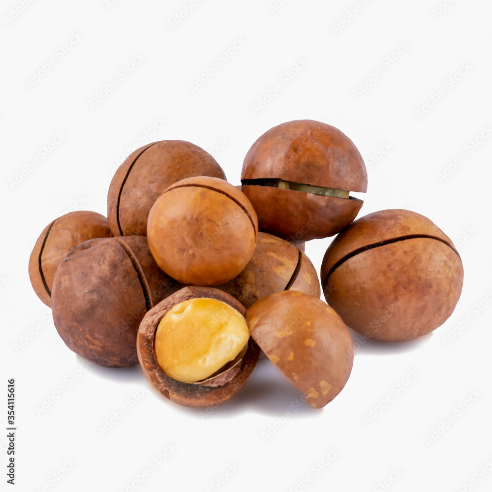 Obraz premium Group of shelled and unshelled macadamia nuts isolated on white.Seeds of the australian nuts also known as macadamia. Macro food photo close up view.