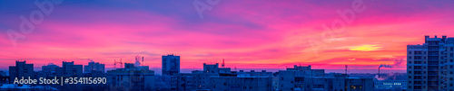 Sunrise over the city  scenic view. Pink-blue sky in soft colors sky above silhouettes of buildings  colorful cityscape for background. Vladimir  Russia