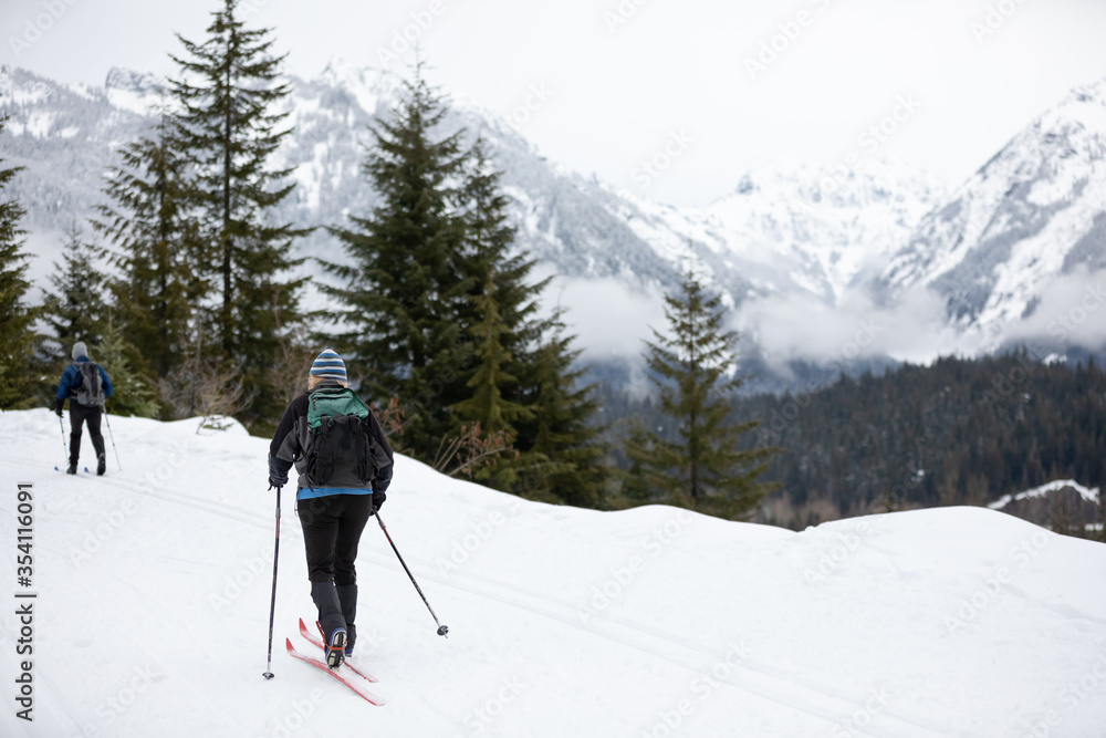 Cross country skiers on a mountain trail, in a snow sport scene
