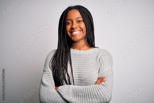 Young african american woman standing casual and cool over grey isolated background happy face smiling with crossed arms looking at the camera. Positive person.