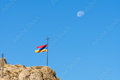 Quadro em tela Armenian flag against a blue sky with a visible moon