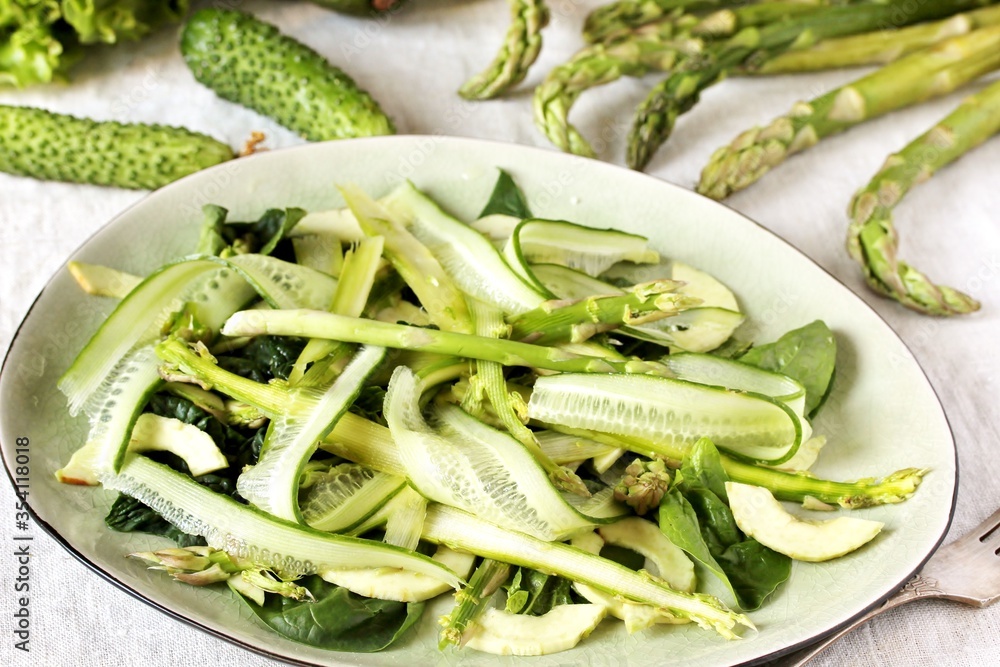 salad of asparagus and cucumber shavings and spinach, thin slices of vegetables with olive oil