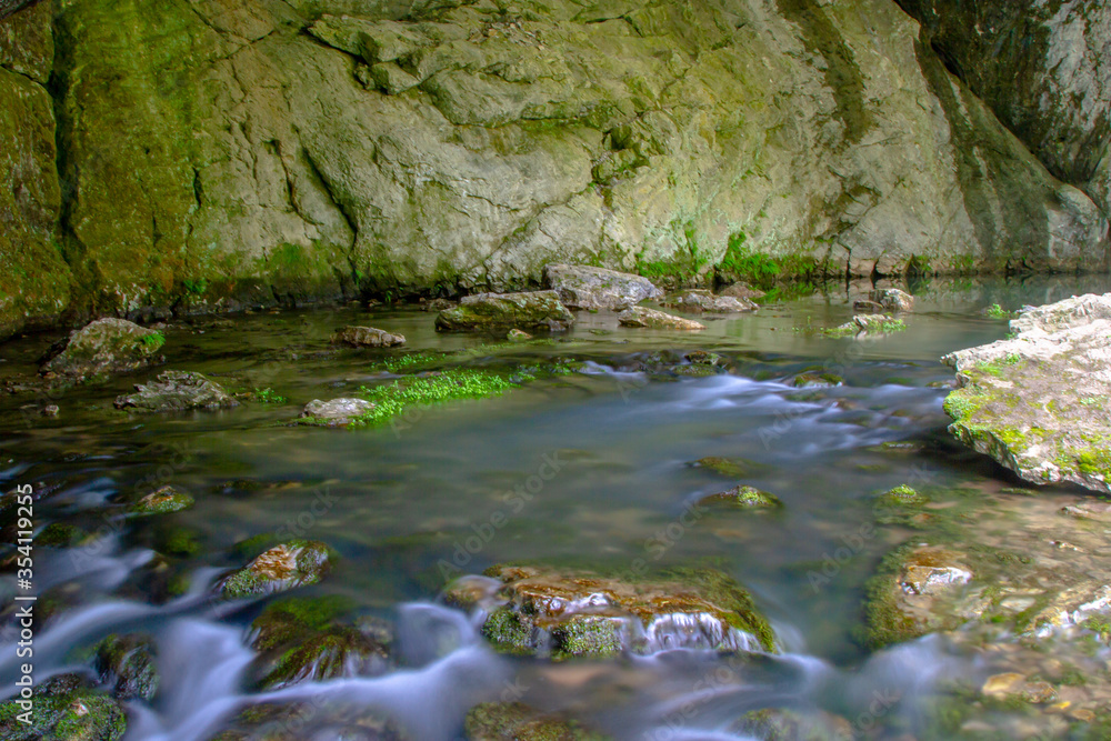 river flowing from a cave