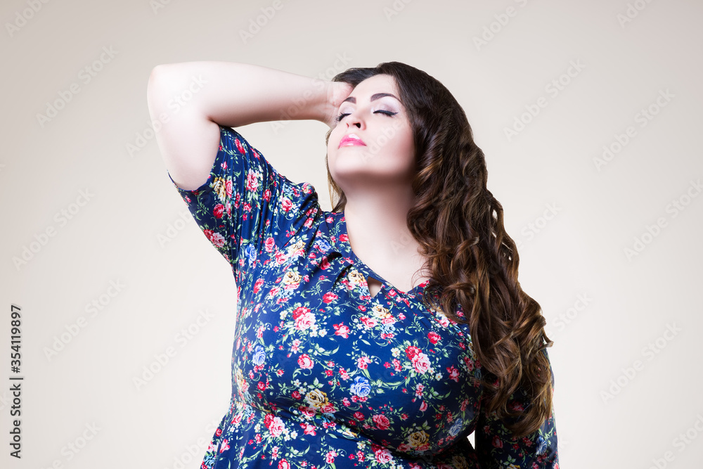 Plus size fashion model in floral blouse, fat woman on beige background Plus size fashion model in floral blouse, fat woman on beige background