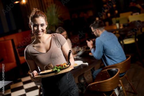 Waiter woman serving group ...