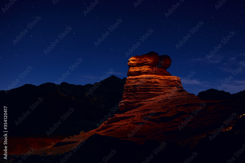 Sandstone rock is illuminated by a flashlight in Herman Cav Canyon at