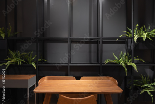 Fototapeta Naklejka Na Ścianę i Meble -  Stylish loft working corner with wood table, leather chair and artificial plant with black metal rod on the background / interior design concept / scandinavian interior