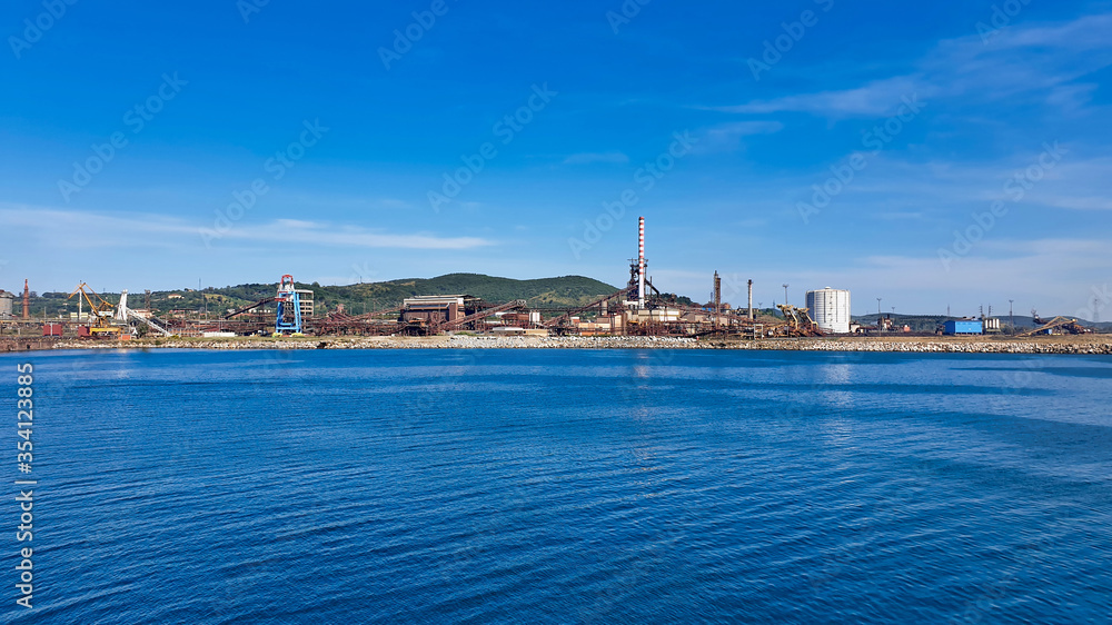 Factory industry plant on the sea, panoramic view. Environmental awareness, concept of ecology and environmental pollution