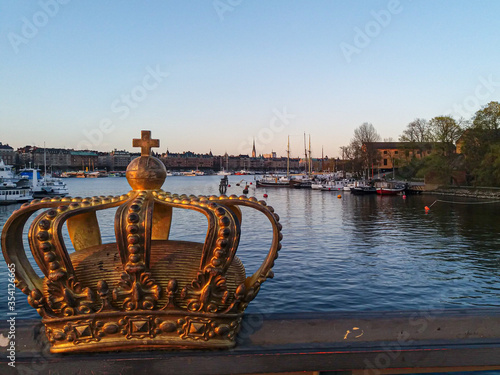 A golden crown on the bridge and cityscape on the background