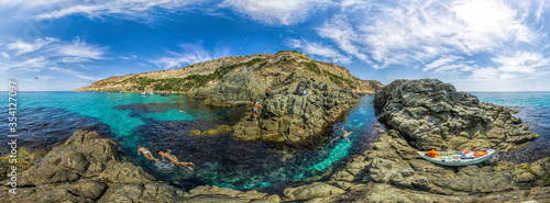 girls dive on Baunty beach, cape Fiolent in Sevastopol, Crimea on a background of rocky shores. The concept of an travel, relax, active and healthy life in harmony with nature. photo