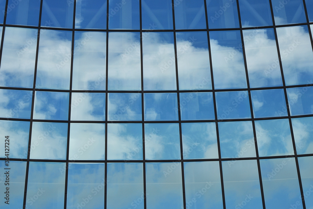 Mirrored glasses of the building in which the sky is reflected Mirrored glasses of the building in which the sky is reflected