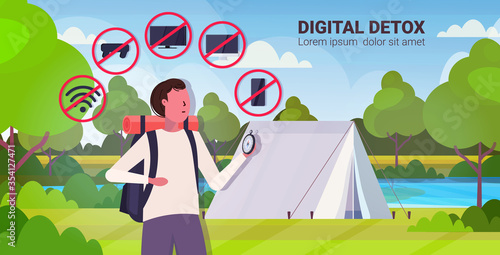 traveler with backpack holding compass gadgets in red prohibition signs digital detox concept guy hiker abandoning devices campsite background horizontal portrait vector illustration
