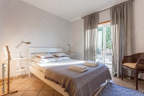 Modern bedroom with a large window. European hotel design.