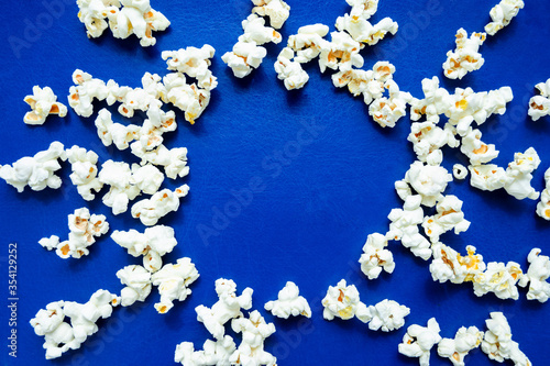 popcorn spread out on a blue background in the shape of a sun the middle is empty space for test entries