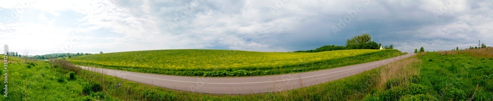 green winter wheat fields and spring sunny day highway with cloudless sky green winter wheat fields and spring sunny day highway with cloudless sky