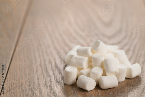 small white marshmallows pile on wooden background
